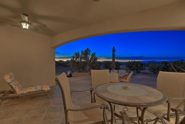 255 Diamond Tail Rd, Placitas, NM 87043 - patio terrace at dusk with outdoor dining space, a ceiling fan, and a patio