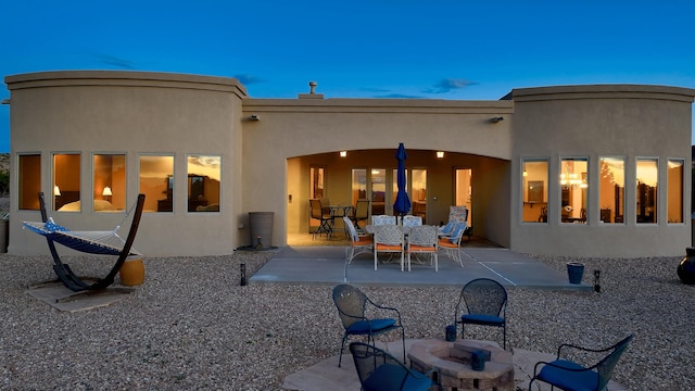 255 Diamond Tail Rd, Placitas, NM 87043 - back of house featuring a patio, a fire pit, and stucco siding