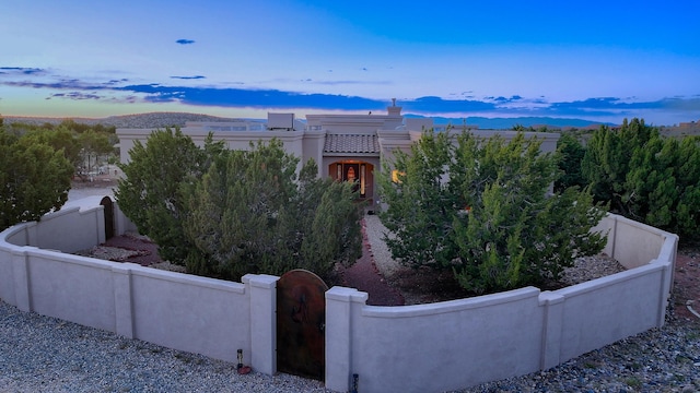 255 Diamond Tail Rd, Placitas, NM 87043 - view of front of property featuring a fenced front yard, a mountain view, and stucco siding