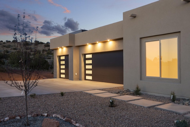 262 Diamond Tail Rd, Placitas, NM 87043 - view of front facade with an attached garage, stucco siding, and driveway