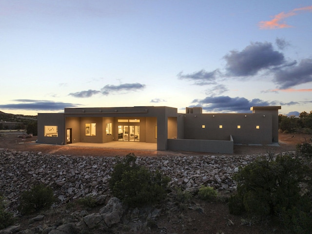 262 Diamond Tail Rd, Placitas, NM 87043 - back of house featuring a patio and stucco siding
