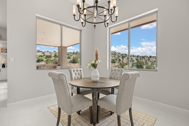 262 Diamond Tail Rd, Placitas, NM 87043 - dining space featuring baseboards and an inviting chandelier