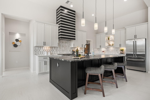262 Diamond Tail Rd, Placitas, NM 87043 - kitchen with a kitchen bar, visible vents, tasteful backsplash, open shelves, and high end fridge