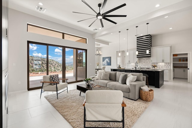262 Diamond Tail Rd, Placitas, NM 87043 - living room with visible vents, recessed lighting, ceiling fan with notable chandelier, and a high ceiling