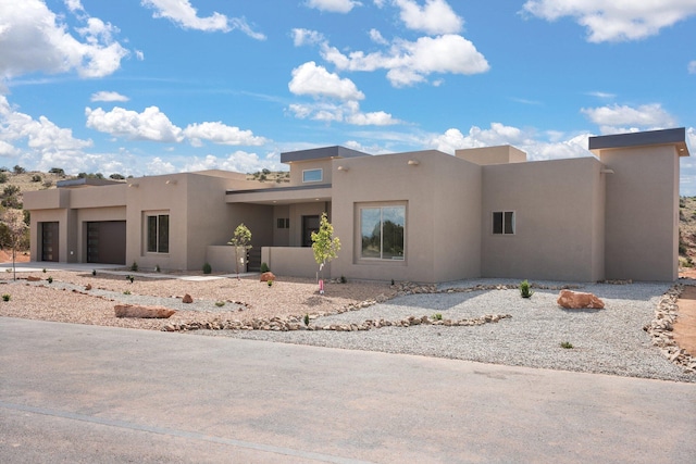 262 Diamond Tail Rd, Placitas, NM 87043 - view of front facade featuring a garage and stucco siding