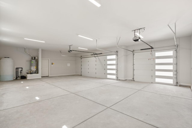 262 Diamond Tail Rd, Placitas, NM 87043 - garage featuring a garage door opener and strapped water heater