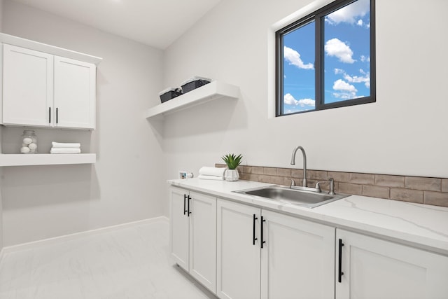 262 Diamond Tail Rd, Placitas, NM 87043 - washroom featuring cabinet space, baseboards, a sink, and marble finish floor