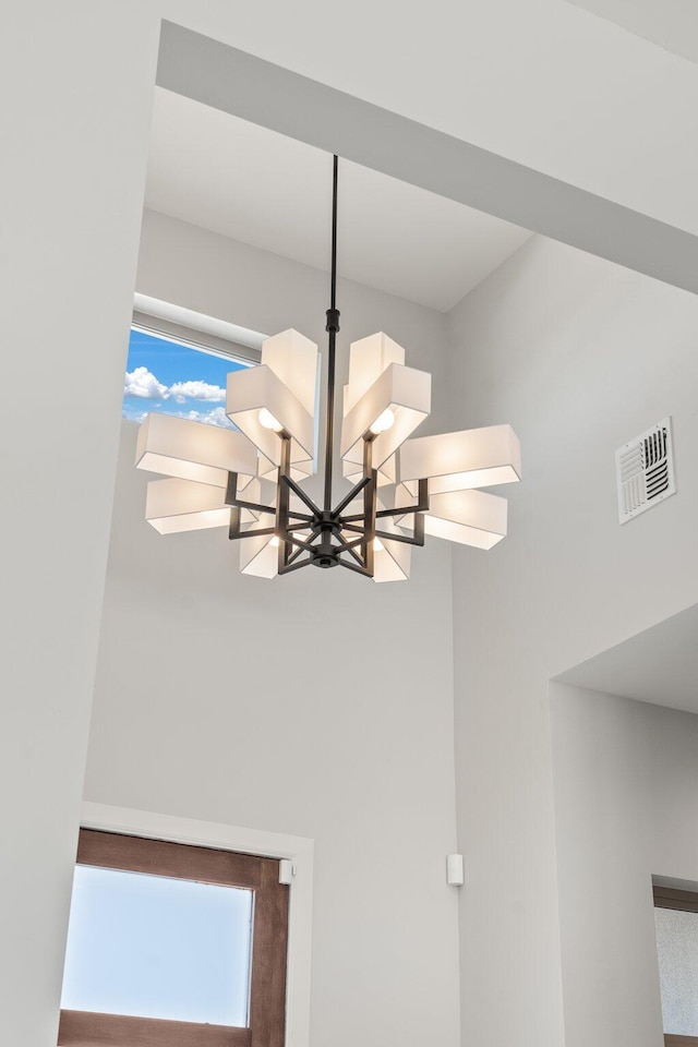 262 Diamond Tail Rd, Placitas, NM 87043 - room details featuring an inviting chandelier and visible vents