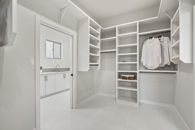 262 Diamond Tail Rd, Placitas, NM 87043 - walk in closet featuring a sink and marble finish floor