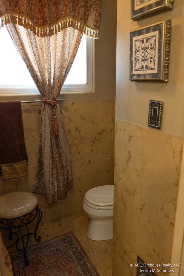 bathroom with toilet and wainscoting