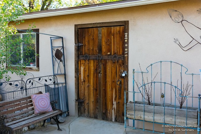 doorway to property with stucco siding
