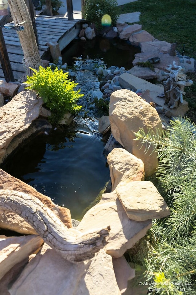 exterior details featuring a small pond