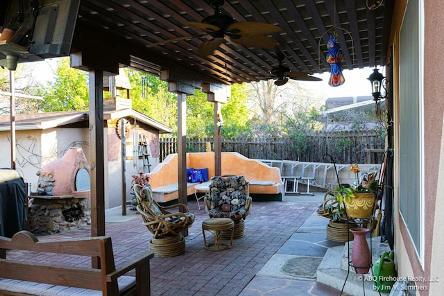 view of patio / terrace featuring an outdoor living space, ceiling fan, and a fenced backyard