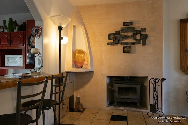 interior space with a wood stove and white microwave
