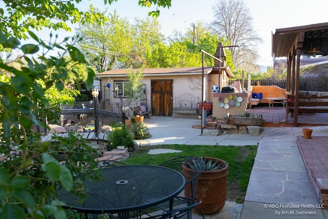 view of yard featuring a patio, fence, and outdoor dining space