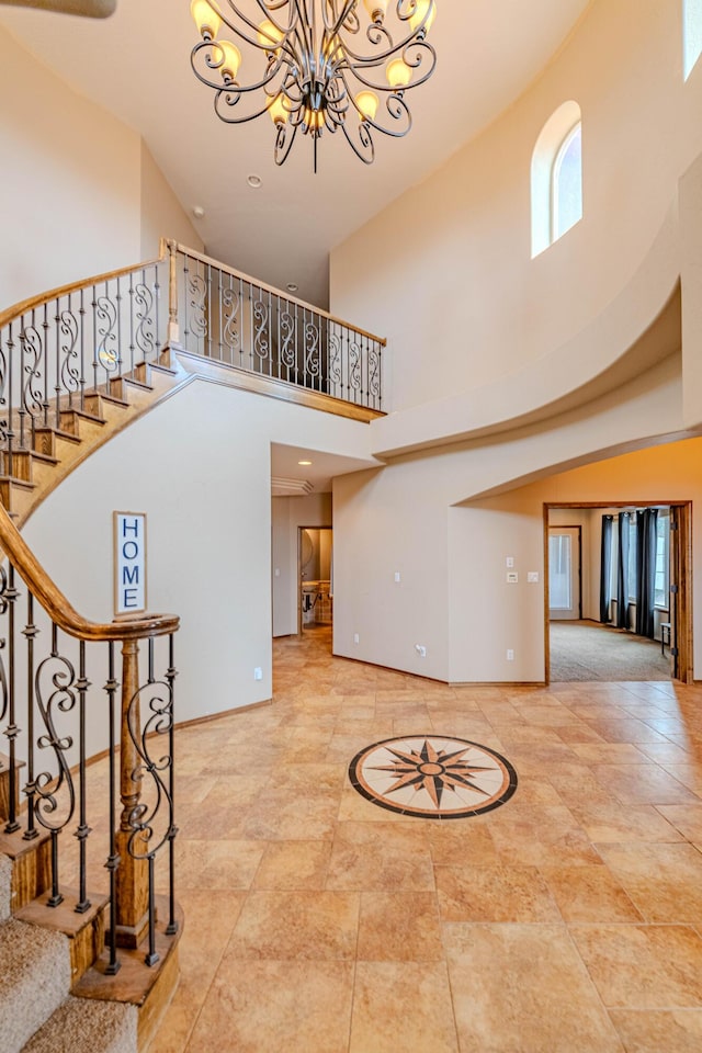 5016 Frontier Rd NE, Rio Rancho, NM 87144 - foyer entrance featuring stairs, baseboards, a towering ceiling, and a notable chandelier