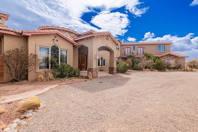 5016 Frontier Rd NE, Rio Rancho, NM 87144 - mediterranean / spanish-style house with a tiled roof and stucco siding