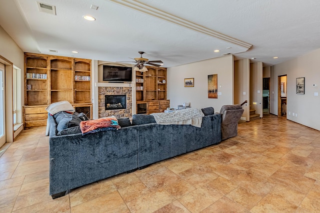5016 Frontier Rd NE, Rio Rancho, NM 87144 - living area with ceiling fan, a stone fireplace, visible vents, and recessed lighting