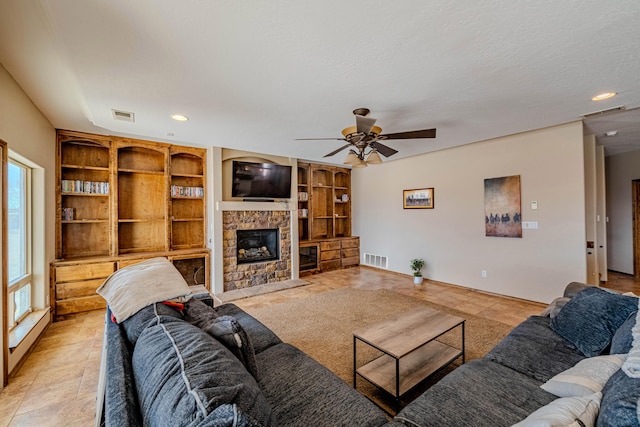5016 Frontier Rd NE, Rio Rancho, NM 87144 - living room with ceiling fan, a stone fireplace, visible vents, and recessed lighting