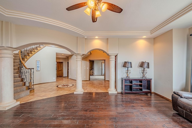 5016 Frontier Rd NE, Rio Rancho, NM 87144 - living room featuring wood finished floors, a ceiling fan, arched walkways, decorative columns, and stairs