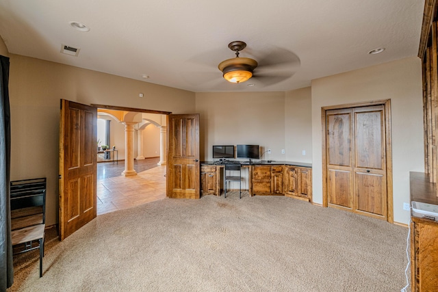 5016 Frontier Rd NE, Rio Rancho, NM 87144 - unfurnished office featuring light carpet, arched walkways, decorative columns, visible vents, and ceiling fan