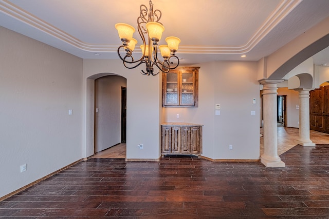 5016 Frontier Rd NE, Rio Rancho, NM 87144 - interior space with hardwood / wood-style floors, arched walkways, a raised ceiling, a notable chandelier, and decorative columns