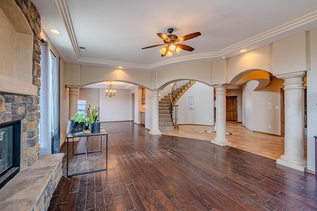 5016 Frontier Rd NE, Rio Rancho, NM 87144 - unfurnished living room with a fireplace, wood finished floors, arched walkways, and a ceiling fan