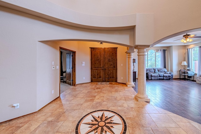 5016 Frontier Rd NE, Rio Rancho, NM 87144 - foyer entrance featuring arched walkways, a ceiling fan, baseboards, and decorative columns