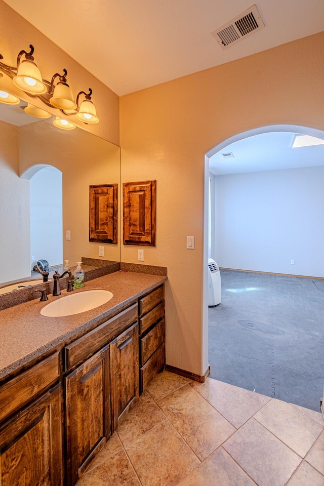 5016 Frontier Rd NE, Rio Rancho, NM 87144 - bathroom with baseboards, visible vents, tile patterned floors, and vanity