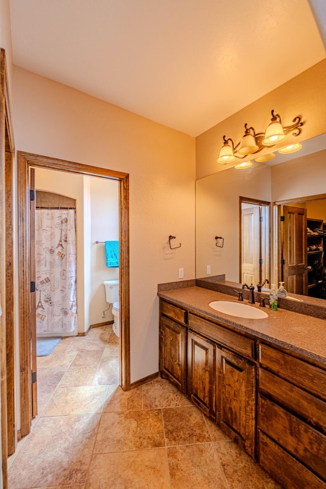 5016 Frontier Rd NE, Rio Rancho, NM 87144 - bathroom featuring stone finish flooring, toilet, and vanity
