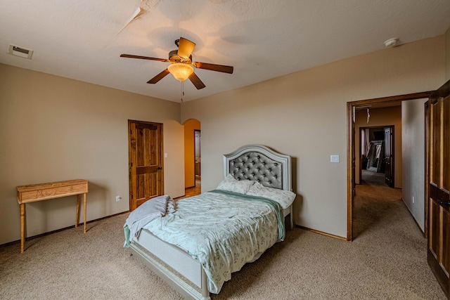 5016 Frontier Rd NE, Rio Rancho, NM 87144 - bedroom featuring a ceiling fan, arched walkways, light carpet, baseboards, and visible vents