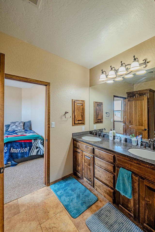 5016 Frontier Rd NE, Rio Rancho, NM 87144 - bathroom with a textured wall, a sink, a textured ceiling, and double vanity