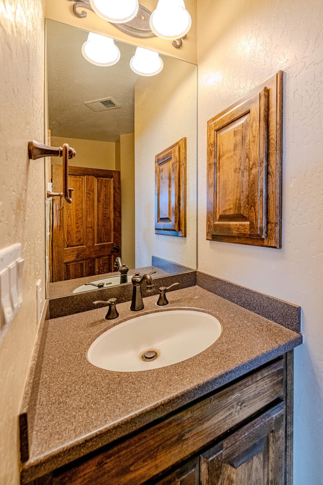 5016 Frontier Rd NE, Rio Rancho, NM 87144 - bathroom featuring a textured wall, vanity, and visible vents