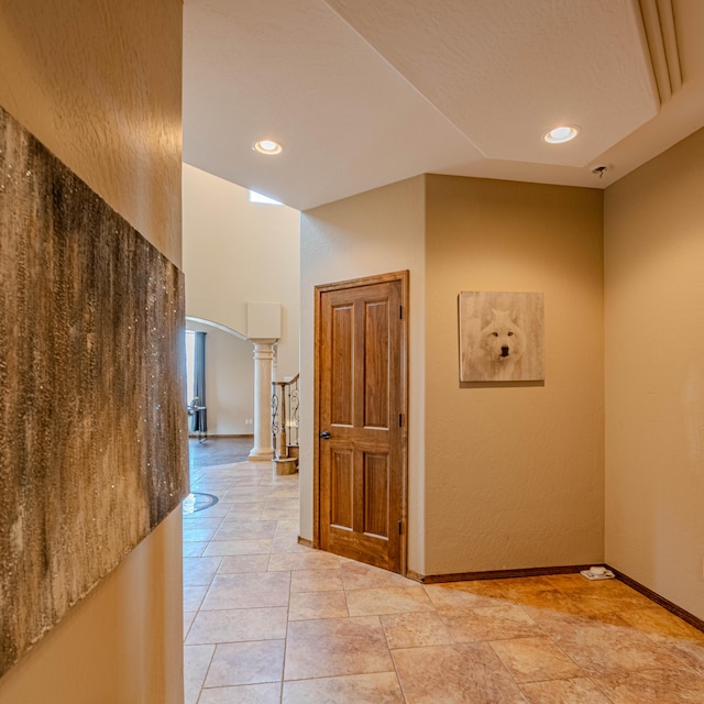5016 Frontier Rd NE, Rio Rancho, NM 87144 - hallway featuring decorative columns, baseboards, arched walkways, and recessed lighting