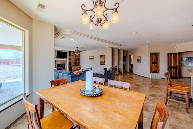 5016 Frontier Rd NE, Rio Rancho, NM 87144 - dining space featuring ceiling fan with notable chandelier, visible vents, a fireplace, and recessed lighting