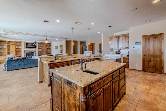 5016 Frontier Rd NE, Rio Rancho, NM 87144 - kitchen featuring a large island, a stone fireplace, a sink, and visible vents