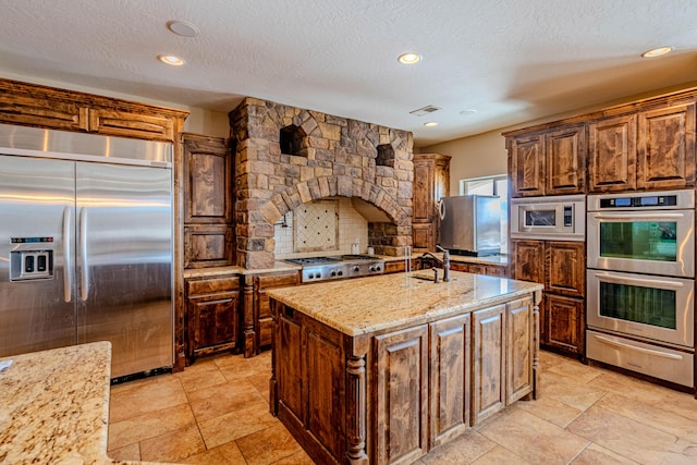 5016 Frontier Rd NE, Rio Rancho, NM 87144 - kitchen with a sink, built in appliances, a warming drawer, backsplash, and light stone countertops