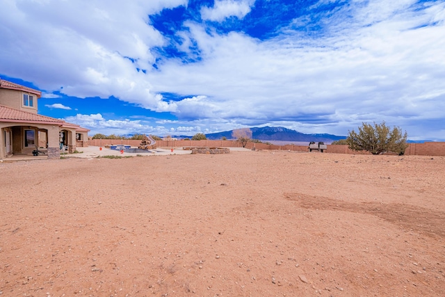 5016 Frontier Rd NE, Rio Rancho, NM 87144 - view of yard featuring a patio area, a fenced backyard, and a mountain view