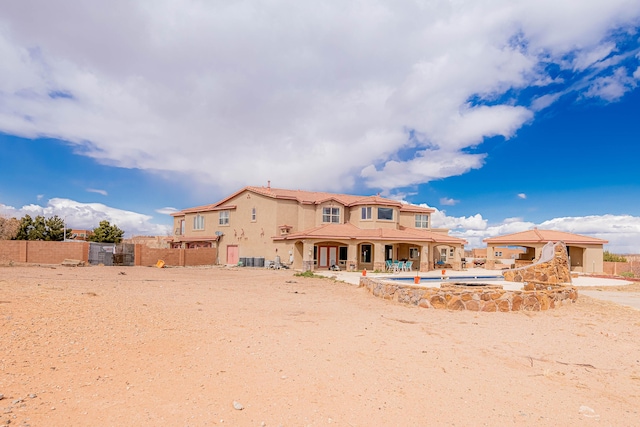 5016 Frontier Rd NE, Rio Rancho, NM 87144 - back of house with stucco siding, fence, a patio area, and a swimming pool