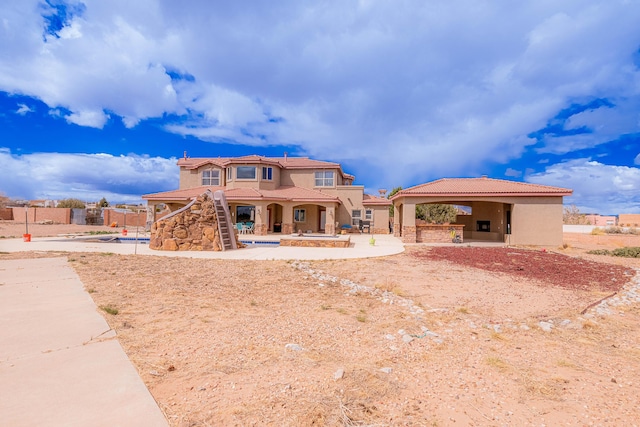 5016 Frontier Rd NE, Rio Rancho, NM 87144 - rear view of house with stucco siding, fence, a tiled roof, and a patio