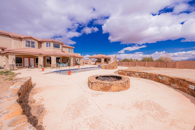 5016 Frontier Rd NE, Rio Rancho, NM 87144 - view of patio with a fire pit, a fenced in pool, and fence
