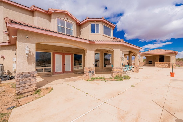 5016 Frontier Rd NE, Rio Rancho, NM 87144 - rear view of house featuring a tile roof, french doors, and stucco siding