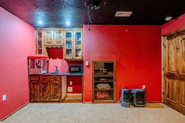 5016 Frontier Rd NE, Rio Rancho, NM 87144 - bar with black microwave, visible vents, carpet flooring, and a textured wall