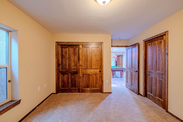 5016 Frontier Rd NE, Rio Rancho, NM 87144 - unfurnished bedroom featuring baseboards, a textured ceiling, pool table, and light colored carpet
