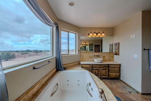 5016 Frontier Rd NE, Rio Rancho, NM 87144 - bathroom with backsplash, a tub with jets, and vanity