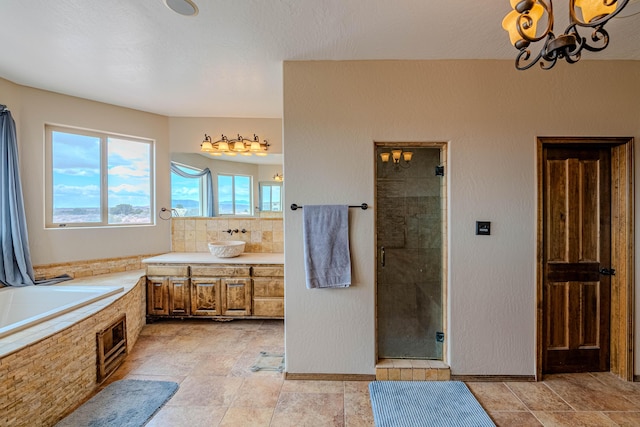 5016 Frontier Rd NE, Rio Rancho, NM 87144 - bathroom with a bath, a stall shower, baseboards, a notable chandelier, and vanity