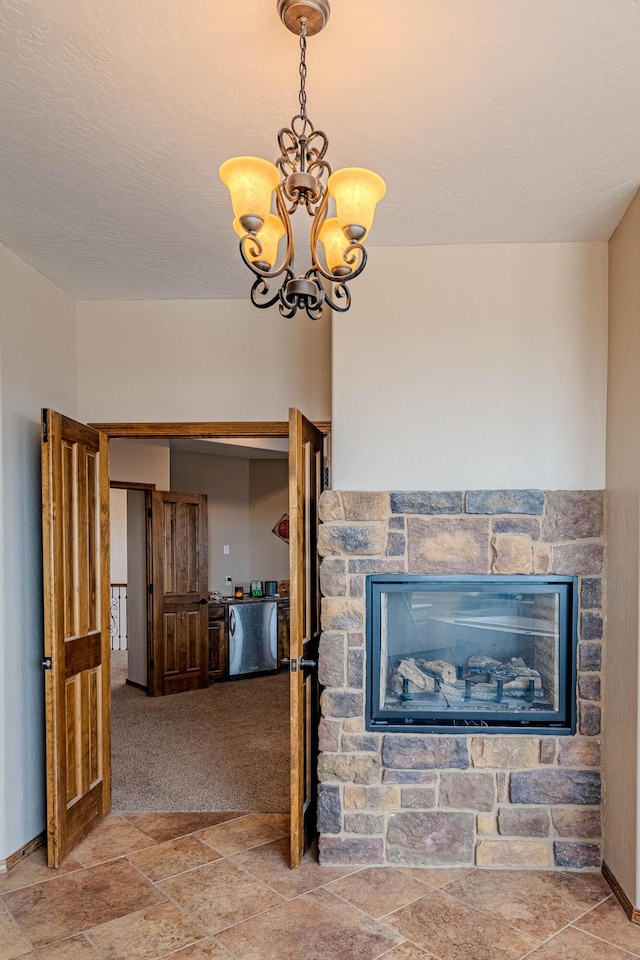 5016 Frontier Rd NE, Rio Rancho, NM 87144 - living room with baseboards, a fireplace, a chandelier, and stone finish flooring