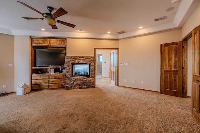 5016 Frontier Rd NE, Rio Rancho, NM 87144 - living area with a stone fireplace, visible vents, light colored carpet, and ceiling fan