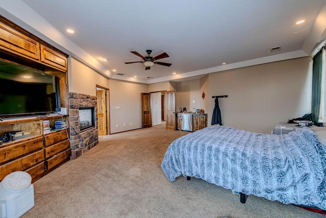 5016 Frontier Rd NE, Rio Rancho, NM 87144 - bedroom with recessed lighting, a stone fireplace, visible vents, light carpet, and baseboards