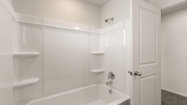 full bathroom with washtub / shower combination and baseboards